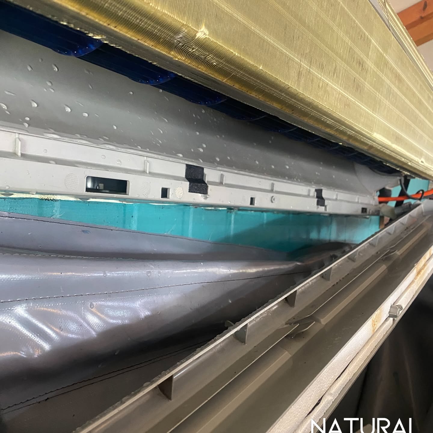 Split system mid-clean with a wash bag catching the run-off